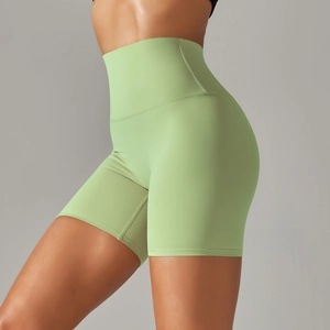Side view of mint green high-waisted yoga shorts showing stretch fabric and body contour