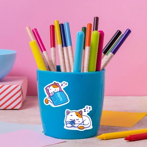 Waterproof cartoon cat stickers showing cute sleeping cats on a blue pen holder