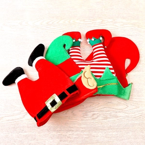 Macro detail of felt Christmas hats with funny elf leg designs and sequins decor