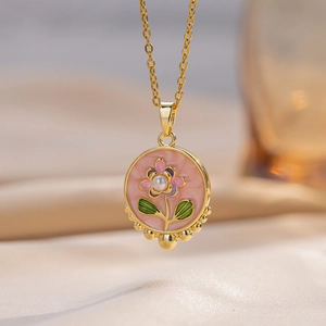Pink enamel flower pendant necklace with central pearl on elegant silk background