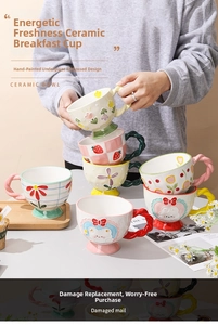 Detail view of hand-painted embossed ceramic mug with strawberry and tulip floral patterns