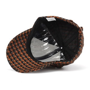 Detail view of plaid baseball cap interior with polyester lining and shape support