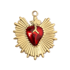 Detailed macro view of vintage red sacred heart pendant with radiant golden metal edges
