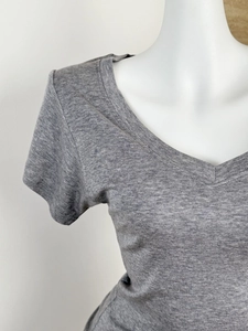 Close-up of the grey V-neck t-shirt showing the tencel wool texture and neck detail