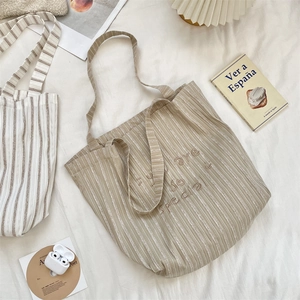 Detail of striped canvas tote with embroidered 'you are so special' text on fabric