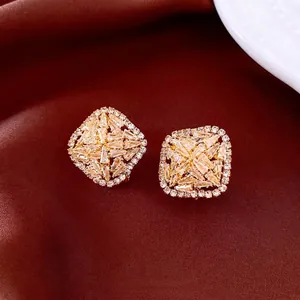 Elegant gold diamond square stud earrings with geometric zircon stones on silk