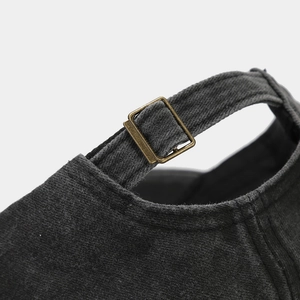 Macro detail of adjustable metal slider buckle and washed canvas fabric on baseball cap