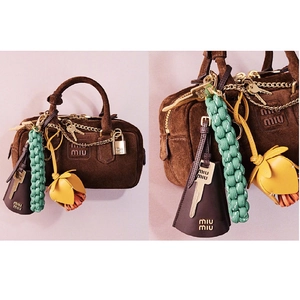 Brown suede handbag with handmade woven pendants and colorful leather accessories