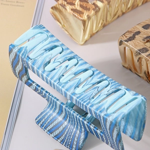 Macro detail of large 10.5cm hair claw clip with blue marble and leopard pattern