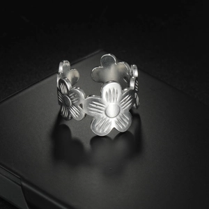 Elegant silver stainless steel open ring featuring a continuous carved floral pattern