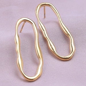 Minimalist gold irregular oval earrings in 304 stainless steel on purple silk background
