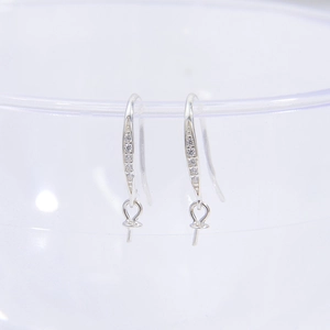 S925 sterling silver earring hooks with white cubic zirconia on a glass edge