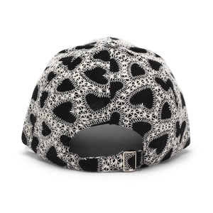 Detail of baseball cap back showing heart embroidery and adjustable silver metal buckle