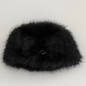 Detail of plush faux fur bucket hat in black with a silver metal ring ornament
