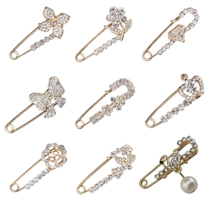 Set of 9 gold-plated swan and flower brooches with rhinestones and pearls