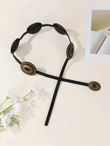 Close-up of vintage black PU leather belt with decorative bronze oval buckles and beads