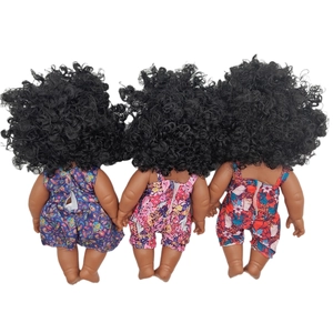 Rear view of African reborn dolls with curly hair wearing colorful floral jumpsuits