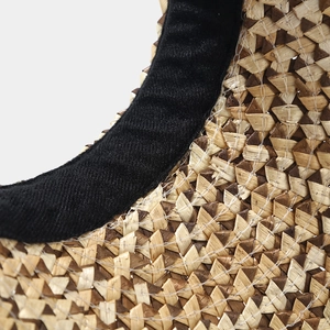 Macro detail of hand-woven straw texture and black inner lining of this sun visor hat