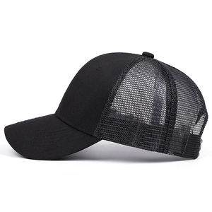 Detailed side view of black trucker hat showing breathable mesh and cotton twill panels