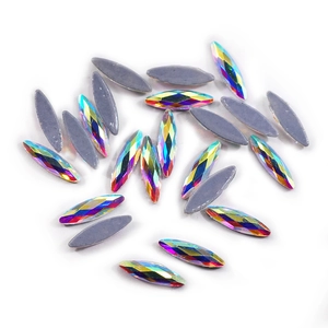Macro view of scattered iridescent navette crystal flatback rhinestones for nail art DIY
