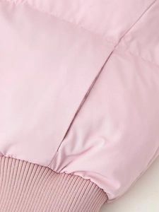 Detail of pink hooded jacket featuring hidden pocket and ribbed knit hemline finish