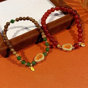 Retro garnet and jasper gourd bracelets with gold pendants in traditional Chinese style