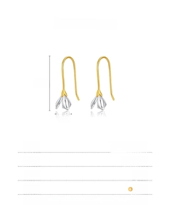 Macro view of S925 sterling silver magnolia flower earrings with gold and silver accents