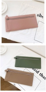 Close-up of slim leather card holders with litchi texture and silver zipper detail