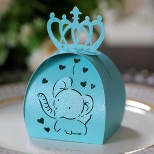 Detail of light blue laser-cut candy box featuring hollow elephant and crown handle