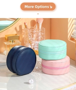 Detailed view of portable leather jewelry organizers in navy, green, and pink colors