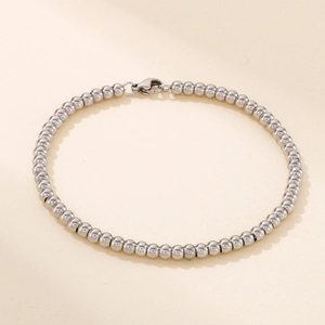 Detail of silver 4mm stainless steel bead bracelet showing the lobster clasp and smooth beads