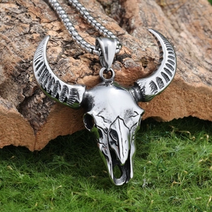 Vintage stainless steel devil ram skull pendant necklace on rustic bark background