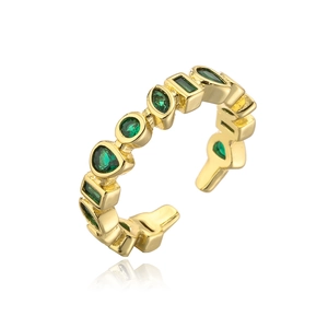 Macro detail of 18K gold-plated ring showing various green zircon stone cuts and settings
