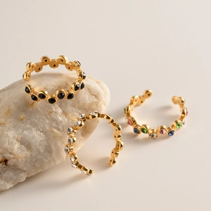 Minimalist snake-shaped titanium steel ring set with gold plating and colorful gemstones