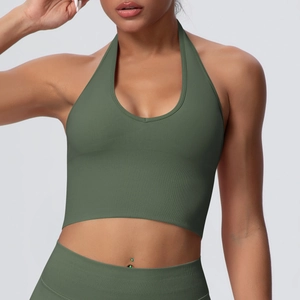 Macro shot of dark green ribbed knit fabric on a halter-neck sports bra and high-waist band