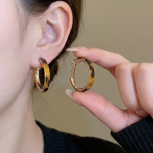 Resin leopard print C-shape hoop earrings with gold metal lining for a stylish luxury look