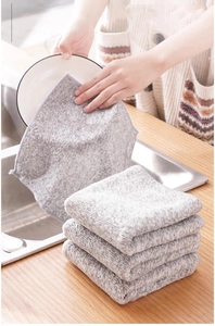 Gray bamboo charcoal fiber dishcloth showing high water absorption during kitchen use