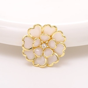 Macro shot of camellia acrylic flower accessory with heart-shaped petals and center zircon