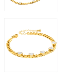 Close-up of gold Cuban chain bracelet with five pavé crystal heart-shaped pendants