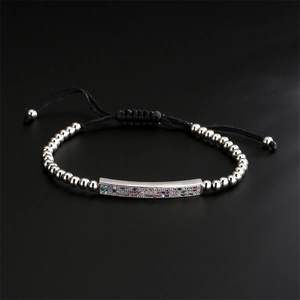 Detailed macro view of woven bracelet with adjustable cord and colorful zircon inlay