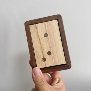 Detail of handcrafted wood frame with dual-tone finish and integrated round magnets