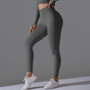 Detail of high-waist seamless scrunch leggings and long-sleeve crop top in dark grey