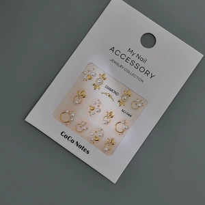 Set de stickers nail art 3D feuilles dorées et perles sur carte de présentation blanche