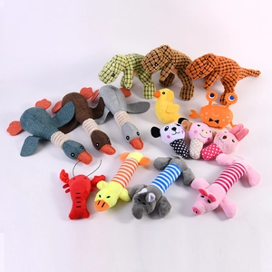 Collection of plush squeaky pet toys in animal shapes like ducks and dinosaurs