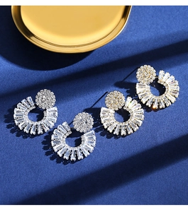 Macro shot of silver sunflower stud earrings with radiant cubic zirconia crystals