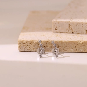 Minimalist silver curved stud earrings with five sparkling white zircons for women