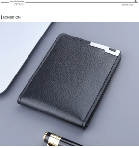 Close-up of black lychee grain leather card holder with silver metal detail on a desk