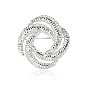 Textured silver knot-shaped geometric metal brooch with a minimalist vintage design