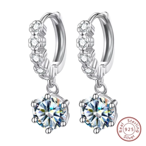 Macro view of 925 sterling silver earrings with round moissanite in six-prong setting