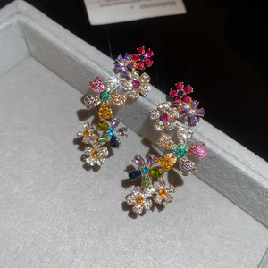 Macro shot of 18k gold plated flower stud earrings with vibrant multi-colored gemstones